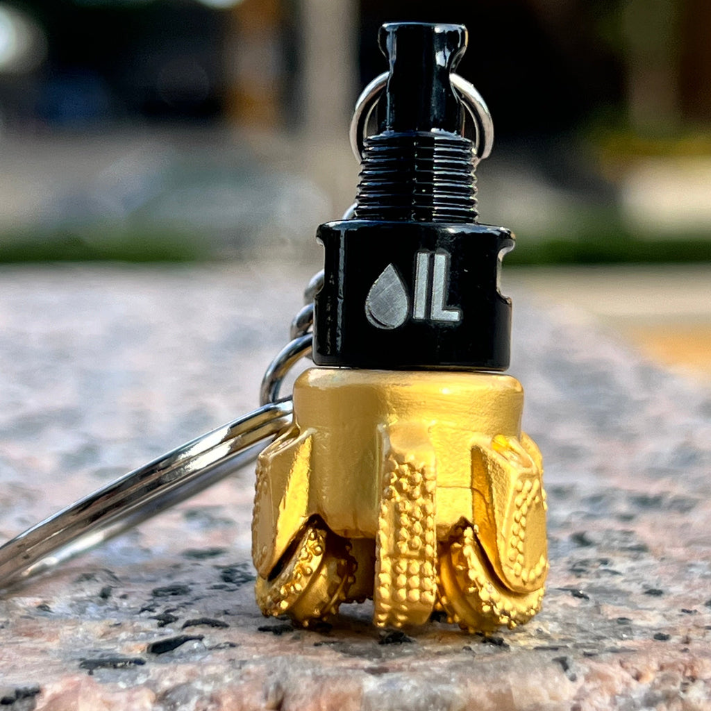 Oil drill bit keychain black and gold