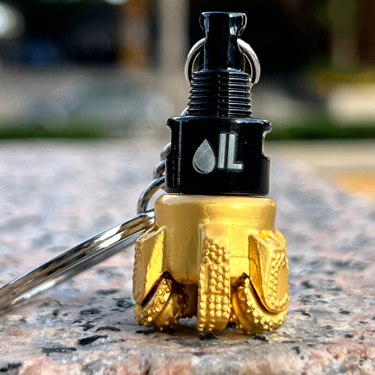 Oil drill bit keychain black and gold