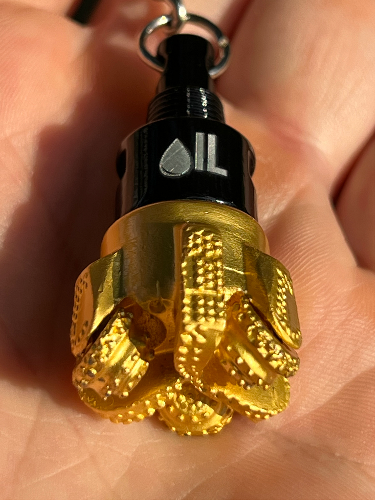 Oil drill bit keychain black and gold