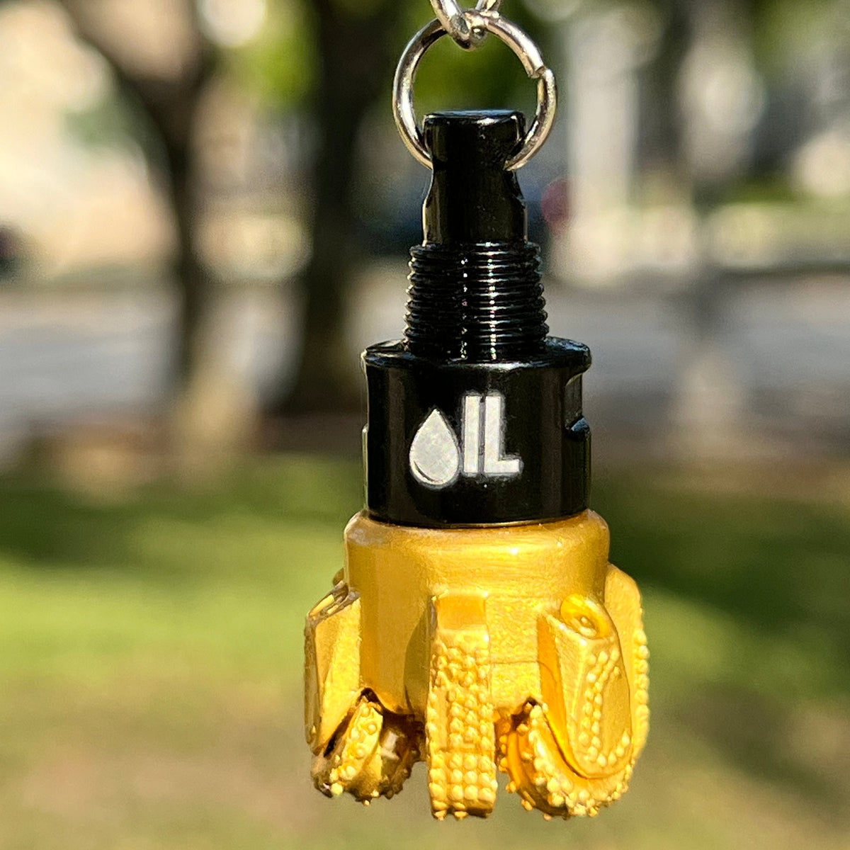 Oil drill bit keychain black and gold