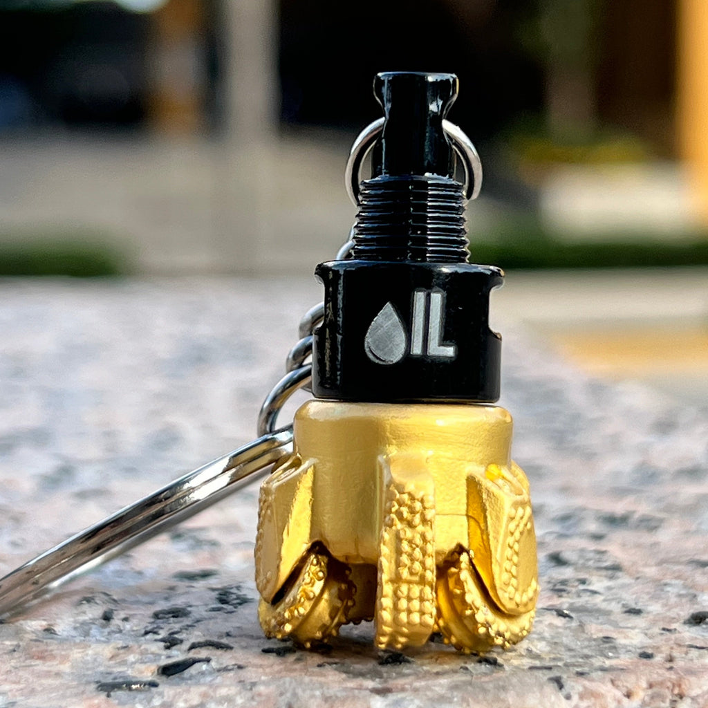 Oil drill bit keychain black and gold